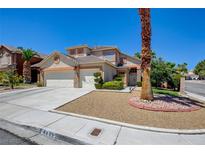 Charming two-story home with a three-car garage, desert landscaping, and well-maintained lawn at 4835 Willow Glen Dr, Las Vegas, NV 89147