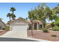 Charming single-story home featuring a well-maintained front yard with mature trees and a two-car garage at 5529 Cranwood Ct, Las Vegas, NV 89130
