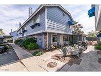 Charming two-story home with blue siding, inviting front patio, and well-maintained landscaping at 5831 Medallion Dr # 103, Las Vegas, NV 89122