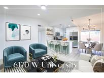 Bright and airy living room featuring modern furnishings, an open layout, and a stylish kitchen at 6170 W University Ave, Las Vegas, NV 89103