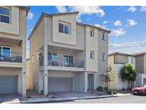 Modern two-story home with a balcony, neutral stucco, and an attached garage, offering contemporary living at 6848 Sunflower Fields St, North Las Vegas, NV 89086