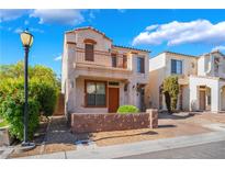 Charming two-story home with stucco exterior, small balcony, and lush landscaping at 9753 Villa Lorena Ave, Las Vegas, NV 89147