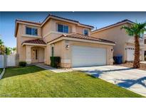 Charming stucco home with a red tile roof, a well-manicured lawn, and a two-car garage at 9773 Sonora Bend Ave, Las Vegas, NV 89148