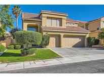 Charming two-story home features a two-car garage, well-manicured lawn, and desert landscaping at 10241 Regents Cross Pl, Las Vegas, NV 89144