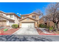 Charming two-story home featuring a two-car garage, landscaped yard, and desert landscaping at 11028 Meadow Leaf Ave, Las Vegas, NV 89144