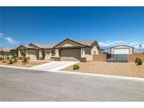 Beautiful single-story home featuring desert landscaping and a spacious driveway, complemented by mountain views at 111 Magnolia Blvd, Pahrump, NV 89048