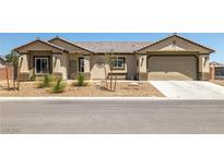 Charming single-story home with desert landscaping and a two-car garage at 111 Magnolia Blvd, Pahrump, NV 89048