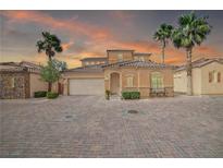 Charming single-Gathering home with desert landscaping, paver driveway, and two-car garage at 153 Via Di Mello, Henderson, NV 89011