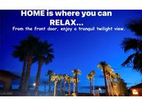 Enjoy a tranquil twilight view surrounded by illuminated palm trees from the comfort of your front door at 153 Via Di Mello, Henderson, NV 89011