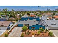 Charming blue two-story home with solar panels and desert landscaping in Las Vegas at 1601 Eaton Dr, Las Vegas, NV 89102