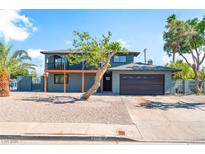 Two-story home featuring a balcony, desert landscaping, and attached two-car garage at 2180 Palora Ave, Las Vegas, NV 89169