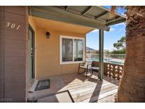 Inviting front porch with seating area and pool view for a relaxing outdoor experience at 301 E Van Wagenen St, Henderson, NV 89015
