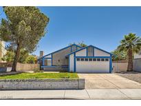 Charming two-story home featuring a two-car garage and manicured front lawn on a sunny day at 318 Heather Dr, Henderson, NV 89002