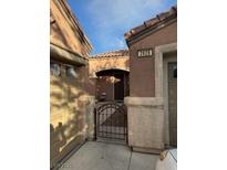 Charming home features an arched porch, metal gate, and desert landscaping at 3928 Ropers Ranch St, North Las Vegas, NV 89032