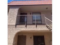Multi-story home featuring stucco siding, a red tile roof, and secure gated entryways at 4300 N Lamont St # 249, Las Vegas, NV 89115