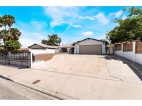 Charming single-story home featuring a large driveway, secure fencing, and low-maintenance landscaping at 4323 E Twain Ave, Las Vegas, NV 89121