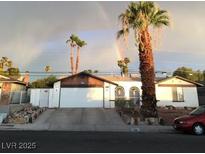 Charming single-story home featuring a spacious driveway and beautiful landscaping at 4461 Greenhill Dr, Las Vegas, NV 89121