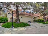 Charming single-Gathering home with mature trees, lush lawn, and a two-car garage at 5112 Onion Creek Ln, Las Vegas, NV 89113