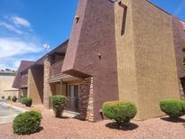 Multi-level apartment building with brown and tan exterior walls, balconies, and manicured shrubbery at 5188 River Glen Dr # 453, Las Vegas, NV 89103