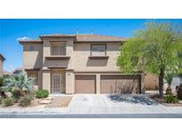 Two-story home featuring desert landscaping, a two-car garage, and a neutral color palette at 54 Blue Fountain Ct, Henderson, NV 89012