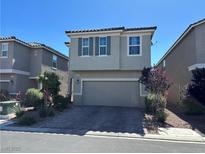 Two-story home featuring a two-car garage, well-maintained landscaping, and a neutral color palette at 5550 Jinan St, Las Vegas, NV 89148