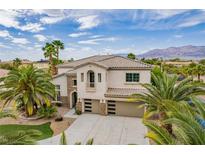 Beautiful two-story home with a three-car garage and desert landscaping at 6214 Ebony Legends Ave, Las Vegas, NV 89131