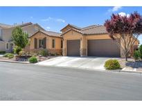 Charming single-story home with a tiled roof and a three-car garage, framed by desert landscaping at 6567 American Eagle Ave, Las Vegas, NV 89131