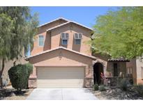 Charming two-story home featuring a two-car garage and well-maintained front yard at 7042 Grand Junction Ave, Las Vegas, NV 89179