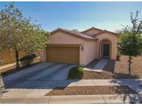 Charming single-story home with a two-car garage and low-maintenance desert landscaping at 711 Golden Sedum Dr, Henderson, NV 89011