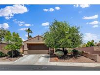 Charming single-story home featuring mature landscaping, a two-car garage, and a welcoming facade at 7152 Fairwind Acres Pl, Las Vegas, NV 89131