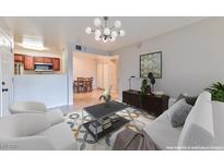 Bright living room featuring modern decor, stylish lighting, and an open layout concept to the kitchen and dining area at 7885 W Flamingo Rd # 1016, Las Vegas, NV 89147