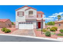 Charming two-story home boasts colorful accents, landscaped yard, and a two-car garage at 7892 Villa Salsa Ave, Las Vegas, NV 89131