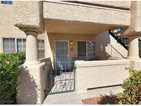 Inviting front entrance with gated access, covered porch, and well-maintained landscaping at 8410 Eldora Ave # 1053, Las Vegas, NV 89117