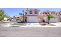 Charming two-story home with a two car garage and low maintenance front yard in a quiet neighborhood at 8507 Titania Ct, Las Vegas, NV 89147