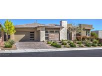 Charming modern home with a stone-accented facade, lush landscaping, and a spacious driveway at 10048 Copper Edge Rd, Las Vegas, NV 89148