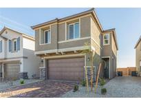 Inviting two-story home featuring a brick driveway, stone accents and a two-car garage at 10328 Apefly St, Las Vegas, NV 89141