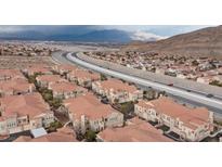 An aerial view shows this residential area nestled near highways and stunning mountain landscapes at 10550 W Alexander Rd # 2082, Las Vegas, NV 89129