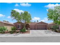 Charming single-story home with a well-manicured front yard and a two-car garage at 11244 Gammila Dr, Las Vegas, NV 89141