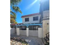 Two-story house with a red tile roof and small fenced yard at 1128 Willow Tree Dr # C, Las Vegas, NV 89128