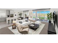 Spacious living room features an open floor plan, modern decor, and large sliding glass doors to the backyard at 180 Native Stone St, Las Vegas, NV 89138