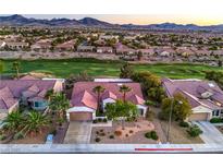 Stunning aerial view of a desert home with lush landscaping and a golf course in the background at 2319 Hardin Ridge Dr, Henderson, NV 89052