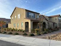 Charming stucco home with a red tile roof and tidy desert landscaping at 2456 Bagnara Pl, Henderson, NV 89044