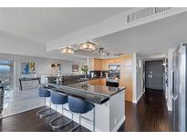 Open kitchen features granite counters, stainless steel appliances, and a breakfast bar with seating at 3111 Bel Air Dr # 16D, Las Vegas, NV 89109