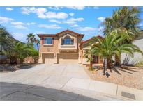 Charming two-story home with a tile roof, desert landscaping and an attached three-car garage at 395 Suzanne Peak Ct, Henderson, NV 89012