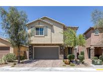 Charming two-story home with stone accents and a well-maintained front yard at 4050 Midnight Crest Ave, North Las Vegas, NV 89031