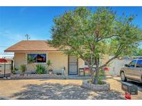 Charming single-story home featuring a spacious front yard with a mature tree providing shade at 4835 Nevada Ave, Las Vegas, NV 89104