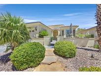 Charming single-story home with lush desert landscaping and stone walkway leading to the front gate at 5068 Rivedro St, Las Vegas, NV 89135