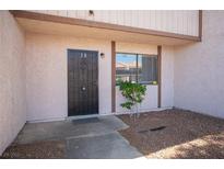 Welcoming front entrance with security door and a small landscaped area at 5241 Janfred Ct # 18, Las Vegas, NV 89103
