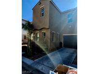 Charming two-story home with a desert-landscaped yard and inviting curb appeal on a sunny day at 5380 Flowing Spring St, Las Vegas, NV 89122