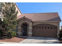 Charming single-story home with a desert landscaped front yard and a brown-toned garage door at 6339 Sharp Rock Ct, Las Vegas, NV 89139
